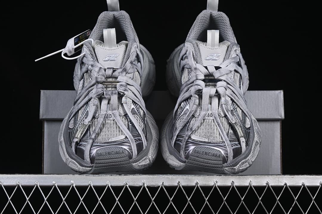 Front view of the pair with lace-up details and branded tongues