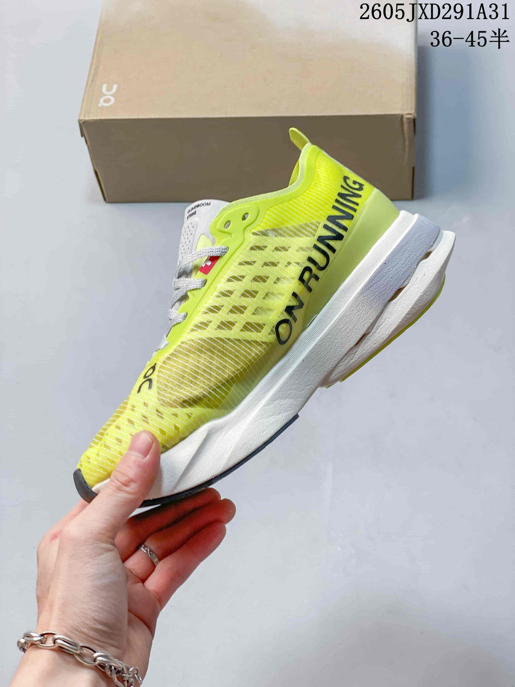 Side view of the shoe showing its yellow-green upper, dark accents, and white midsole.