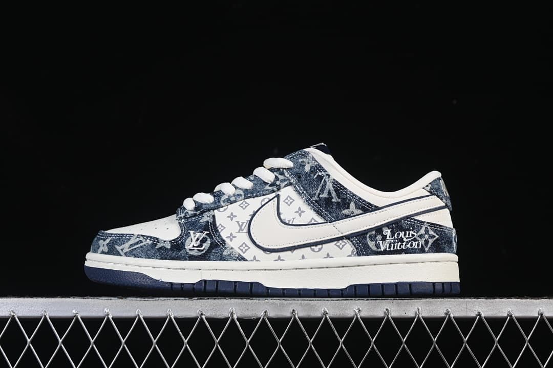 Side view of white and blue Nike SB Dunk Low sneakers with patterned overlays