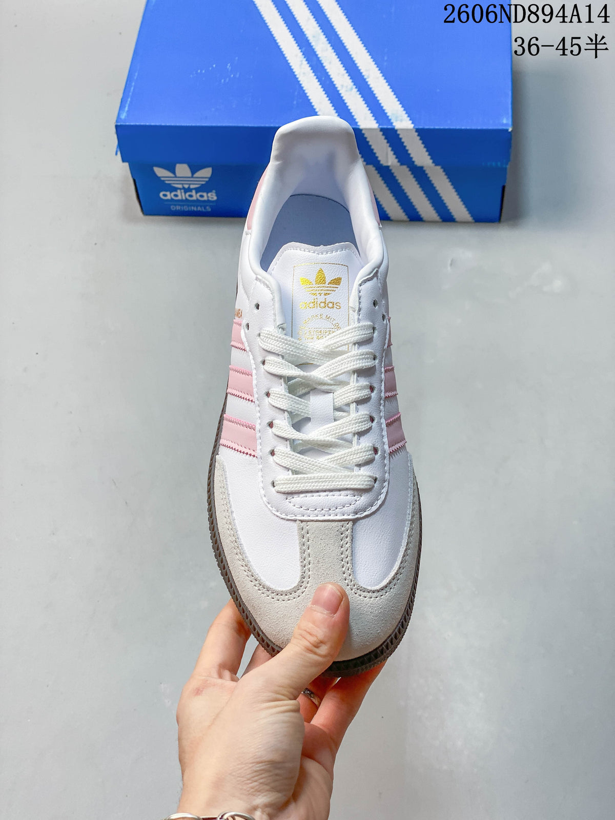 Top view of a white adidas Samba OG sneaker with pink accents, light beige toe overlays, and white laces.