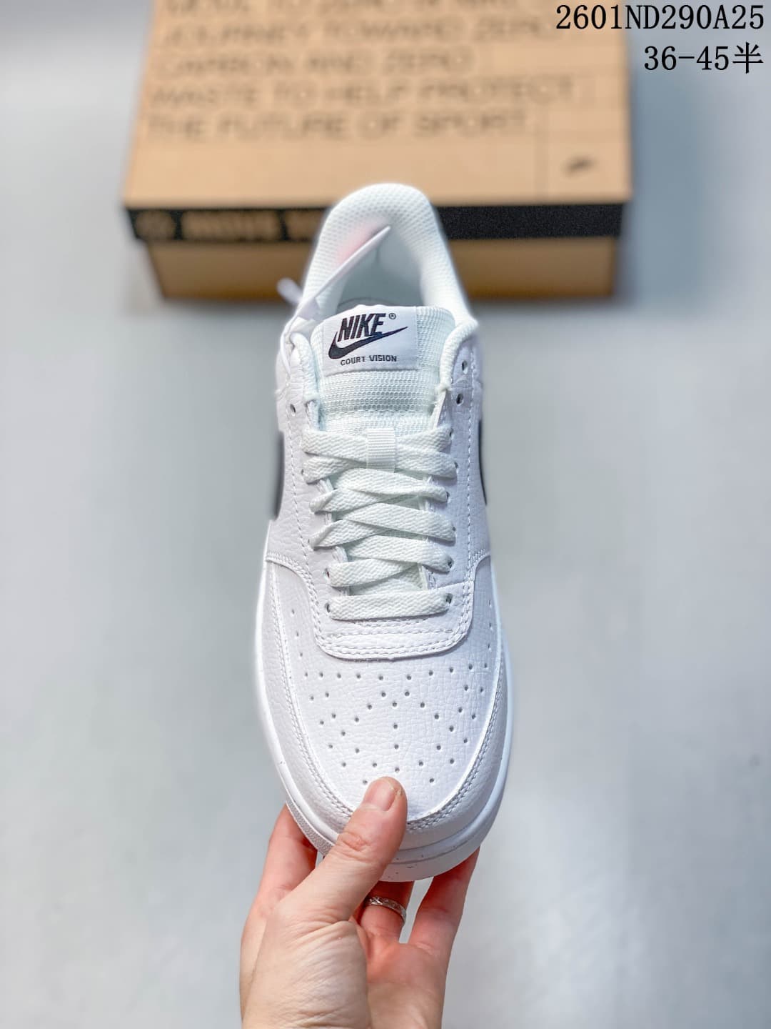 Front view of a white Nike sneaker showing the perforated toe and lace-up closure