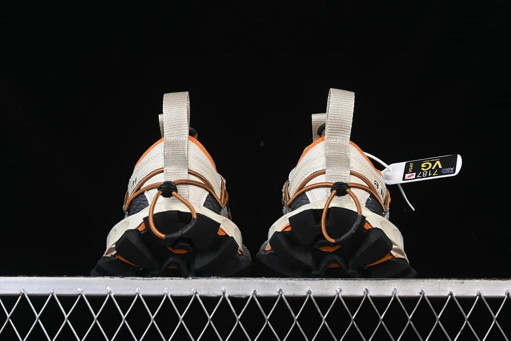 Rear view of both sneakers showing the lugged heels