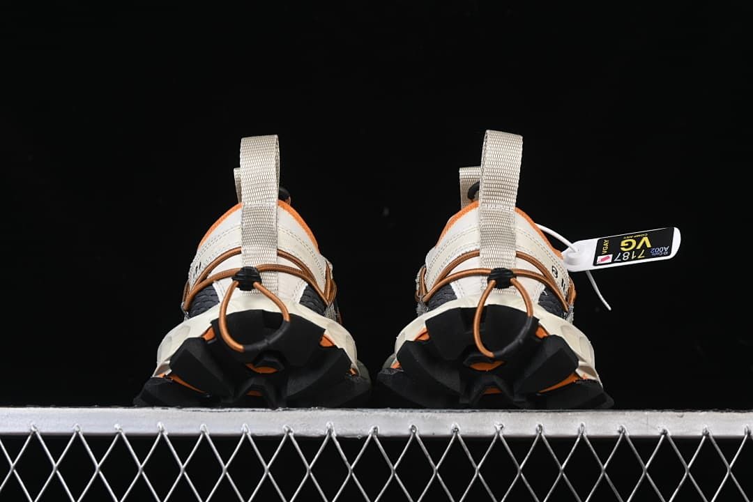Rear view of both sneakers showing the lugged heels