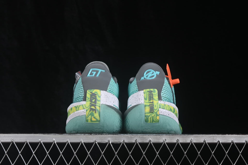 Rear view of the pair showing gray heel panels, GT branding, lime graphic heel details, and translucent soles.