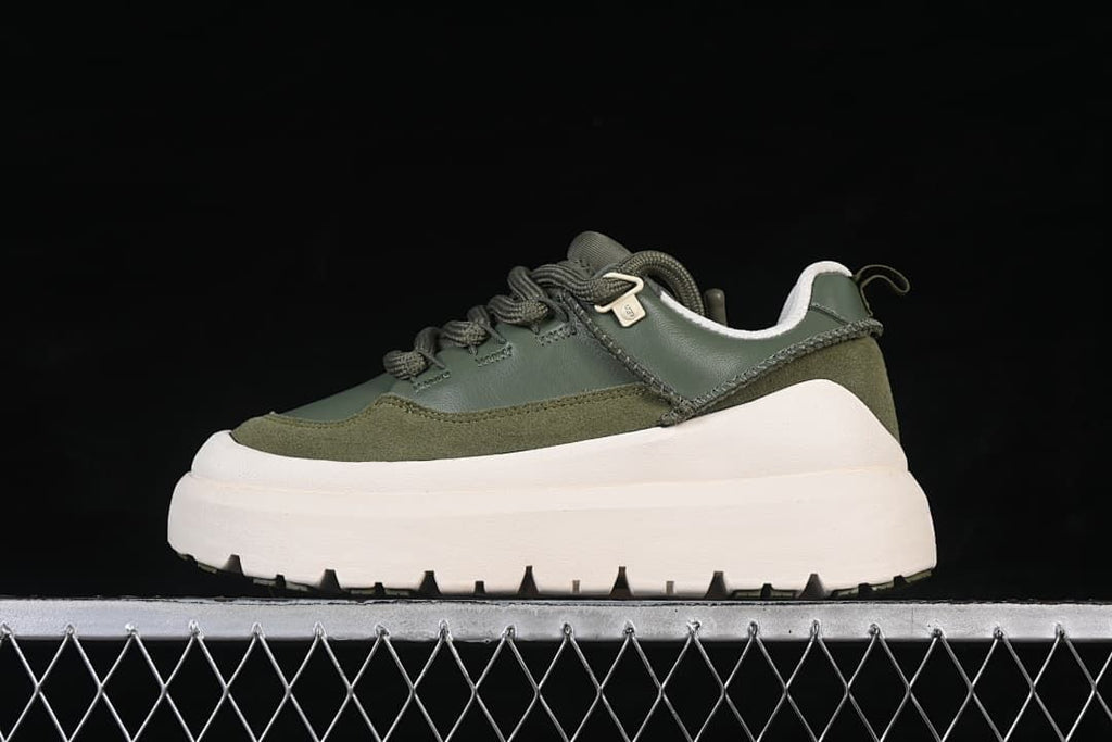 Side view of a green UGG Heritage Utility Sneaker with an off-white chunky sole