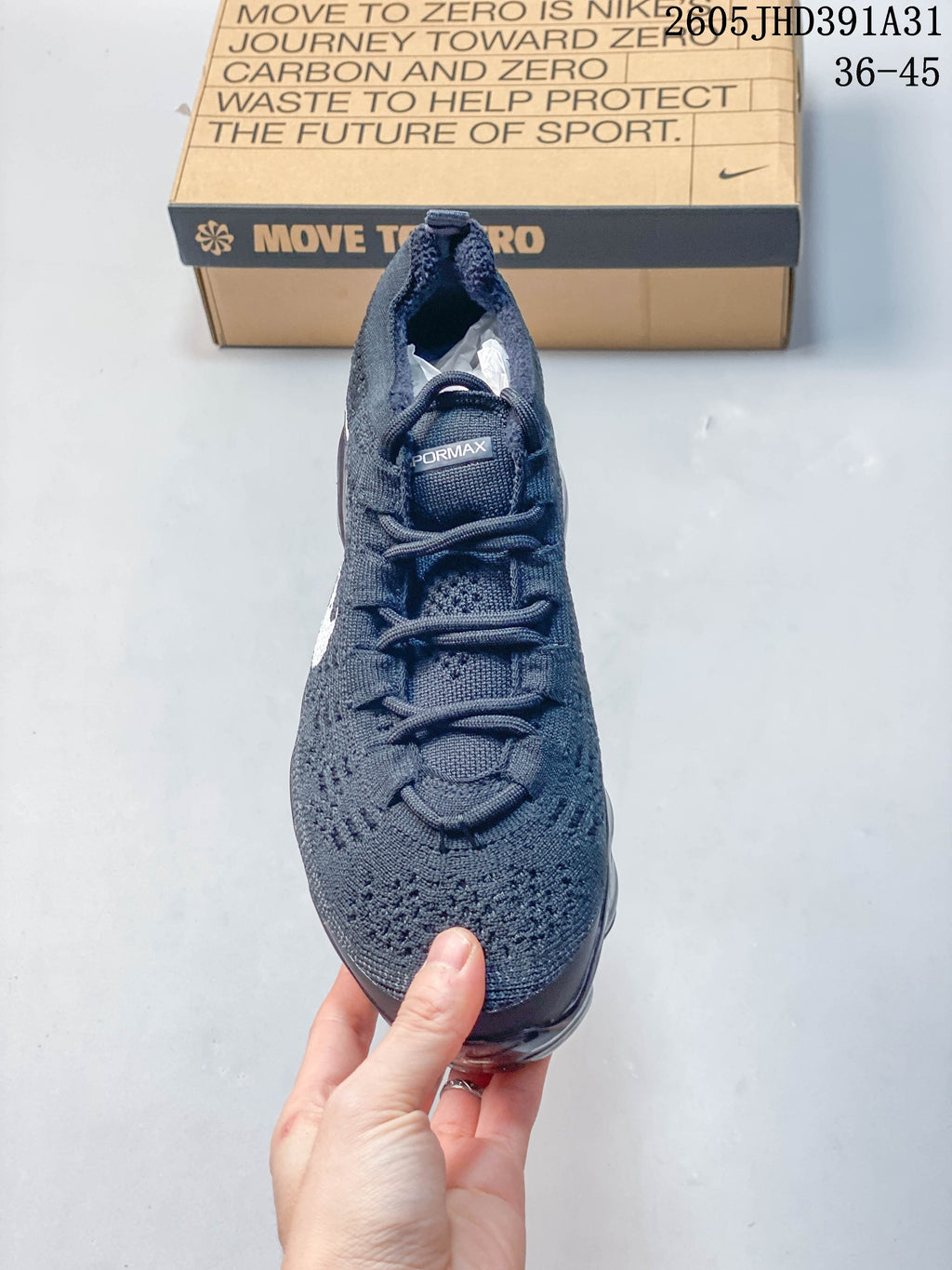 Front view of the knit upper and laces on a dark blue Nike Air VaporMax shoe