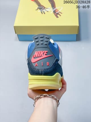 Rear view showing the sneaker’s heel logo, blue upper, and yellow midsole