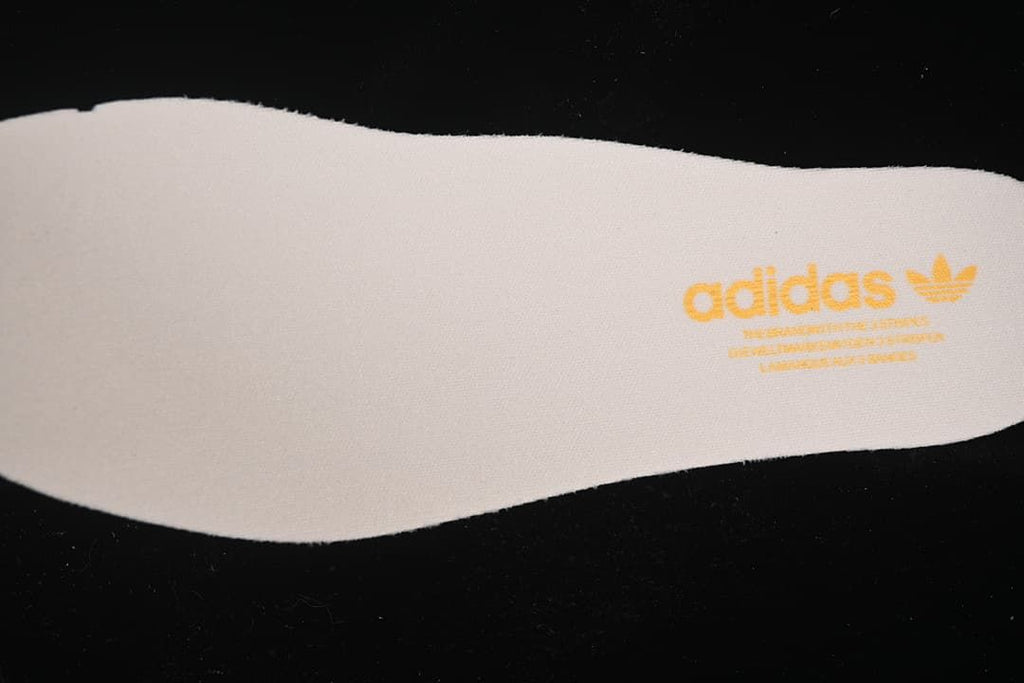 Close-up of an insole with gold adidas Originals branding