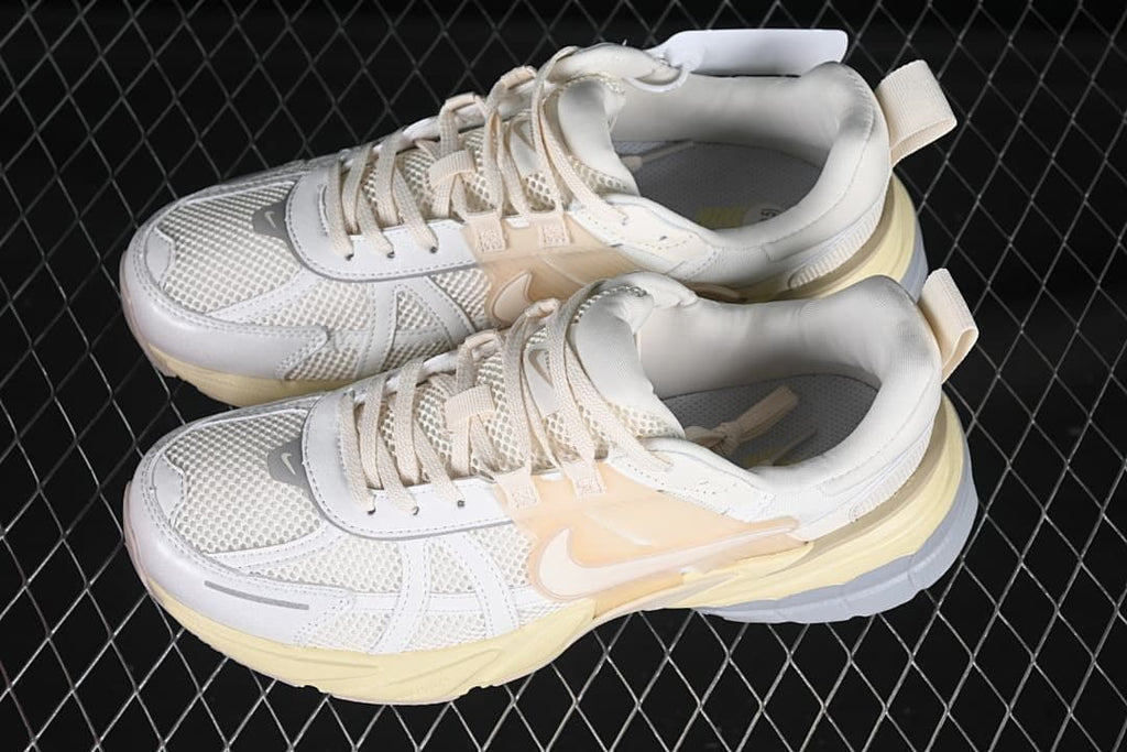 Pair of white and pale yellow Nike V2K Run sneakers viewed from above
