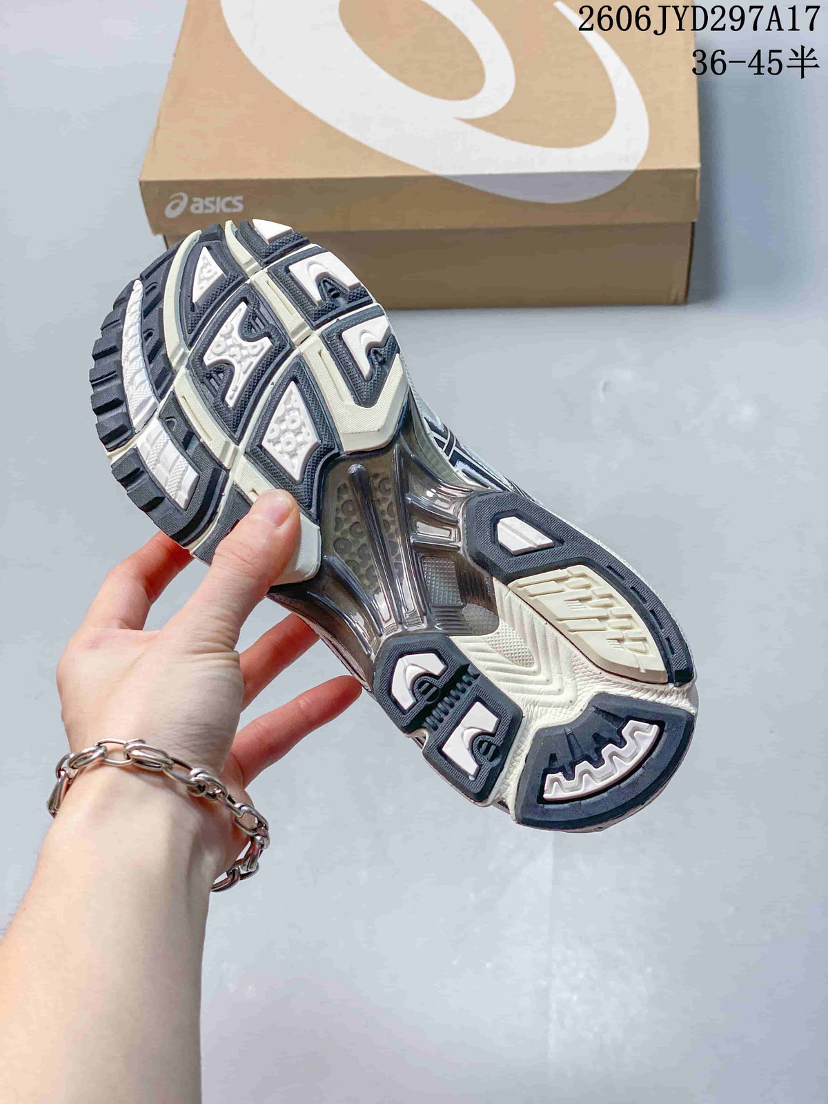 Close-up of the sneaker outsole showing dark and light tread sections and a visible midfoot structure.