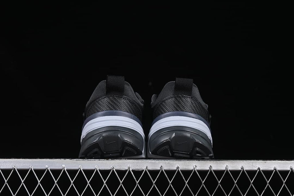 Rear view of both shoes showing their heels and soles