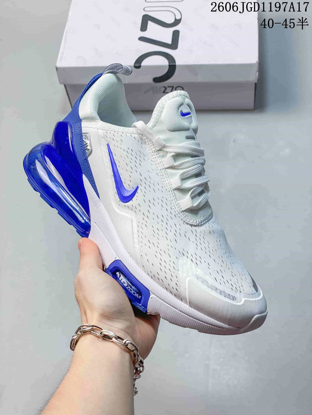 Close-up of a white Nike Air Max Pulse shoe with blue accents and a visible heel air unit.