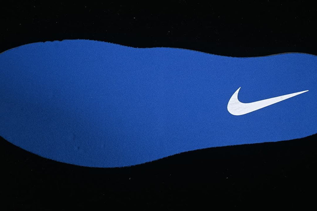 Blue shoe insole with a white Nike Swoosh