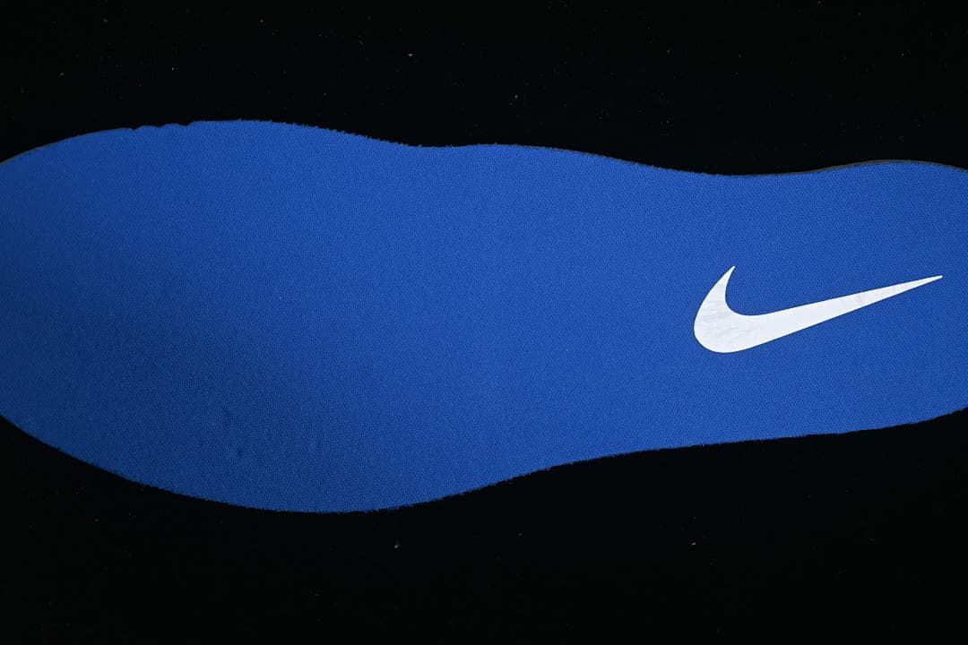Blue shoe insole with a white Nike Swoosh