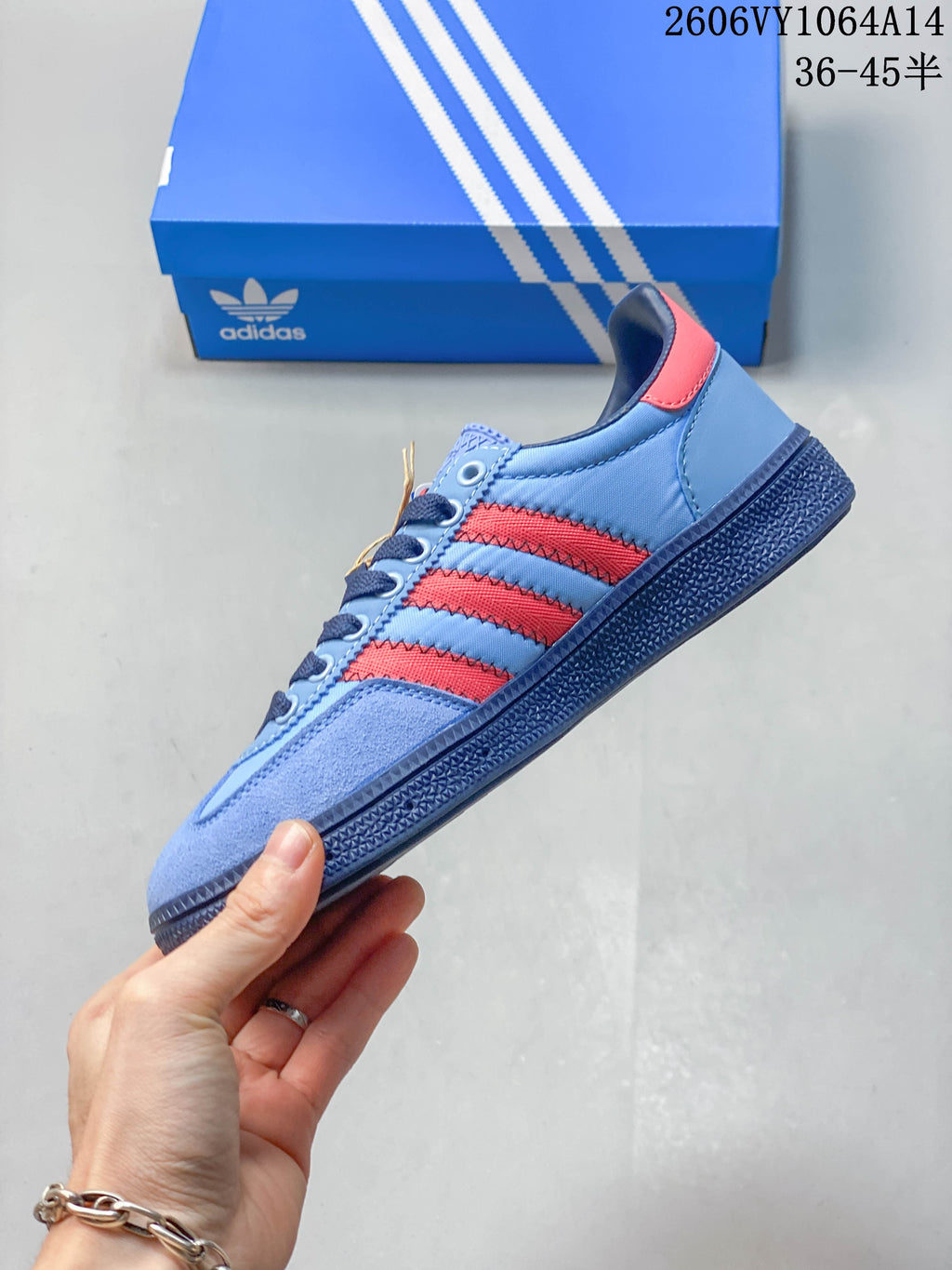 Side profile highlighting the red stripes and light blue upper
