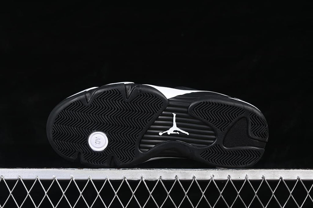 Underside showing the black tread and midfoot emblem