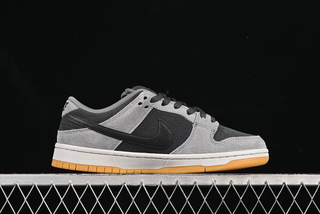 Side profile showing the grey and black upper, white midsole, and gum outsole