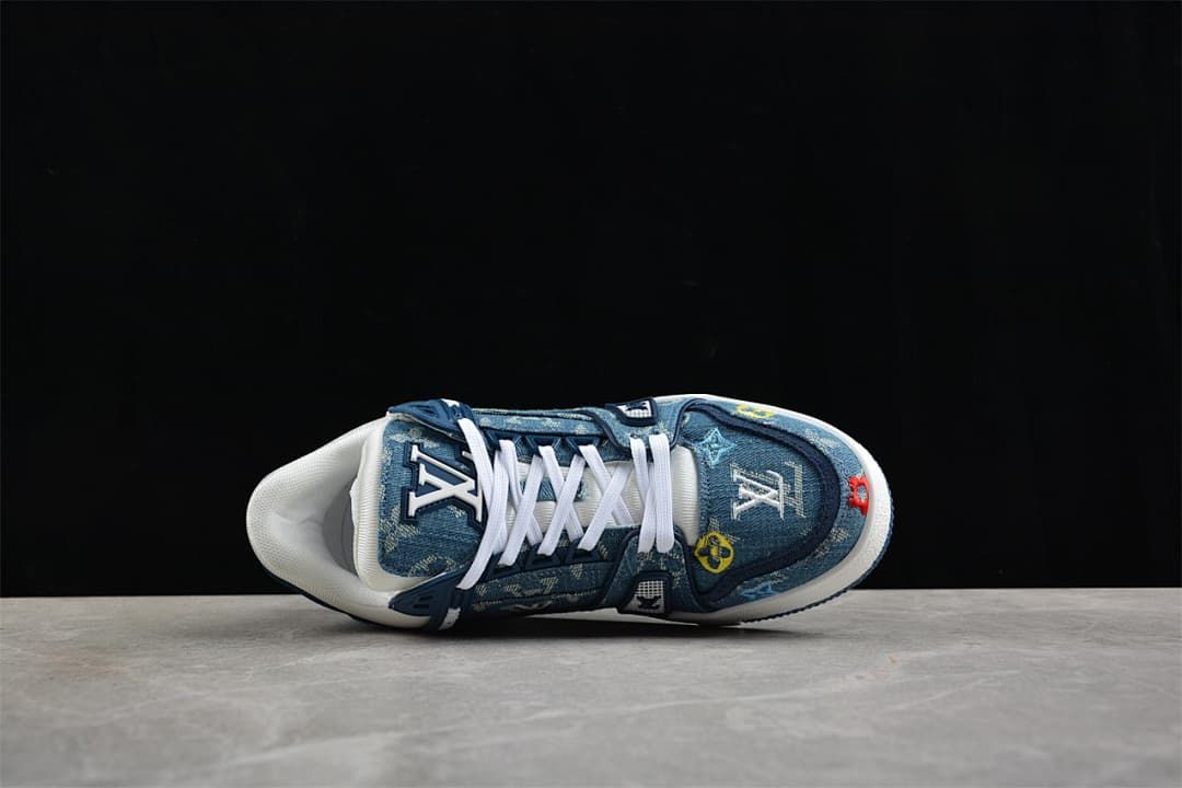 Top-down view of a blue patterned sneaker with white laces.