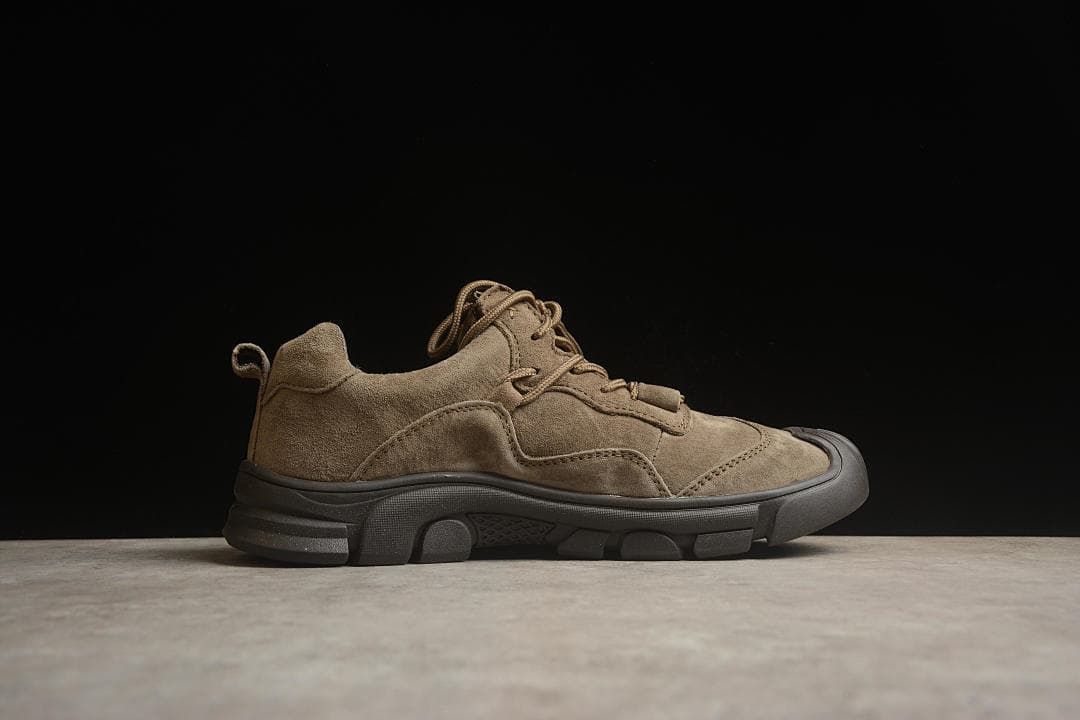 Side profile of a brown low-top shoe with a dark outsole.