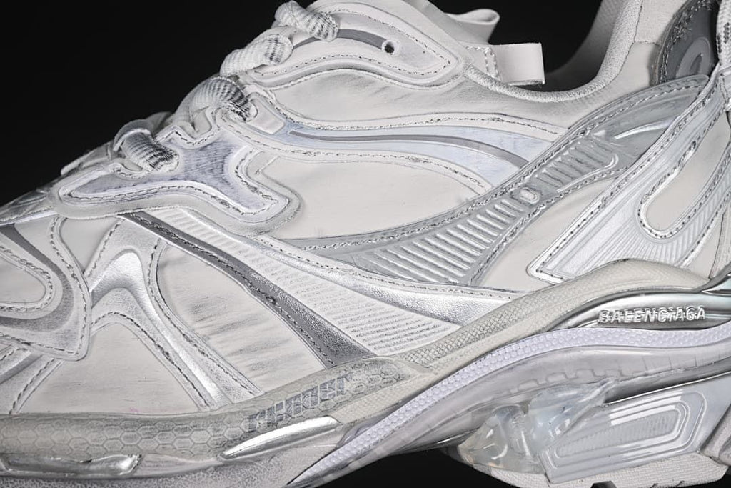 Close-up of the layered grey and silver side panels and laces.