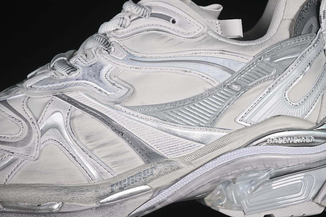 Close-up of the layered grey and silver side panels and laces.