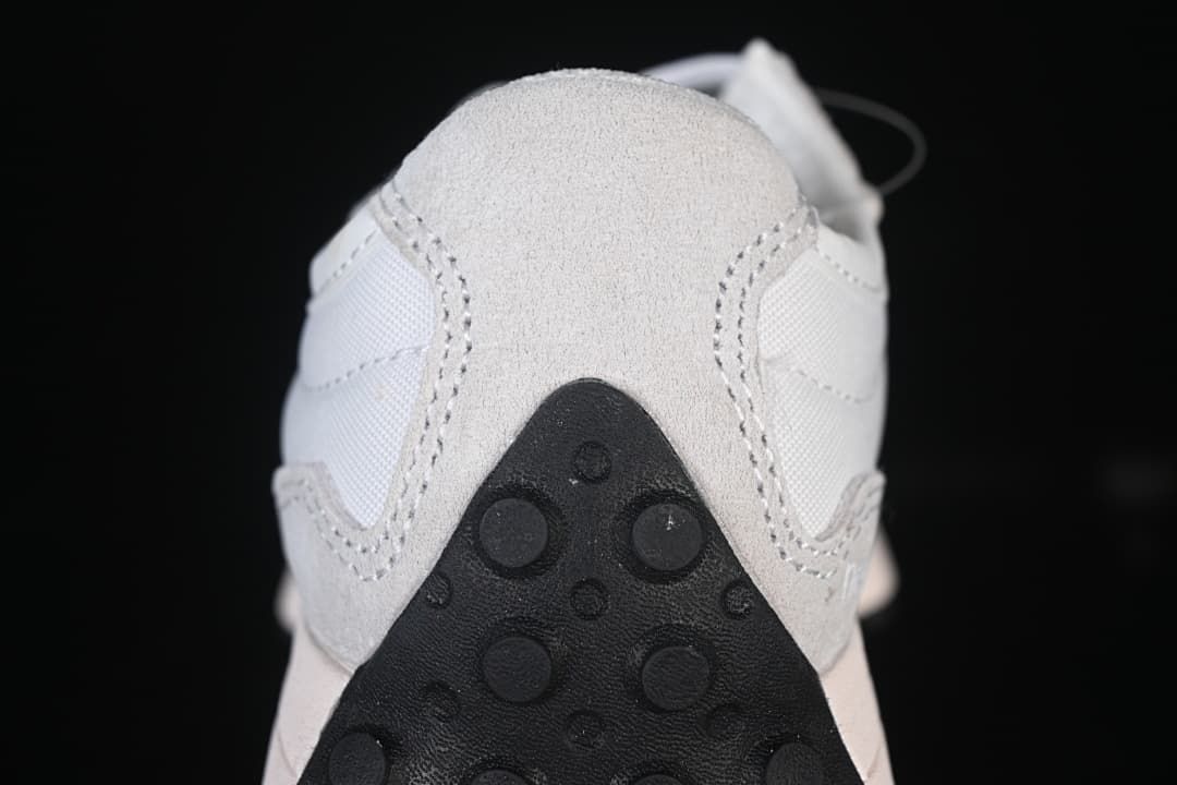Rear close-up of the sneaker showing the gray heel overlay and dark outsole.