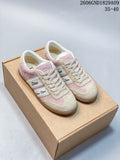Pair of pink and beige Dior Ribbon low-top sneakers on a box
