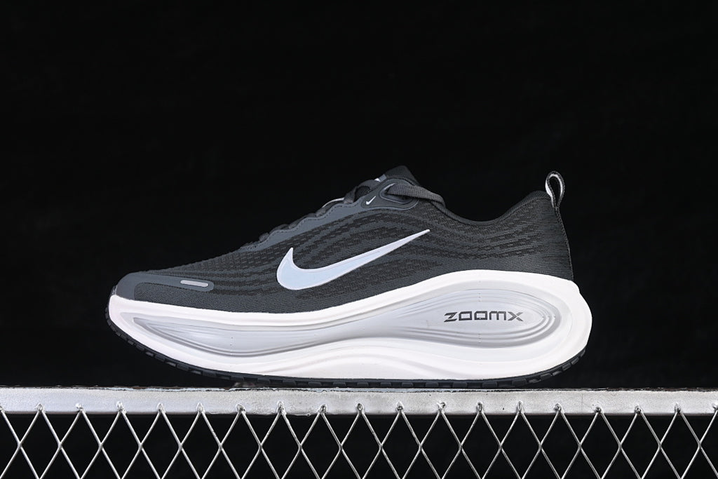 Opposite side view of the dark Nike Vomero Plus running shoe with a light-colored Swoosh.