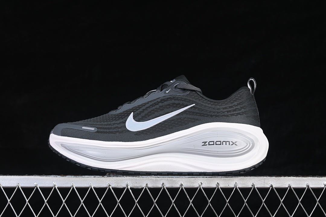 Opposite side view of the dark Nike Vomero Plus running shoe with a light-colored Swoosh.