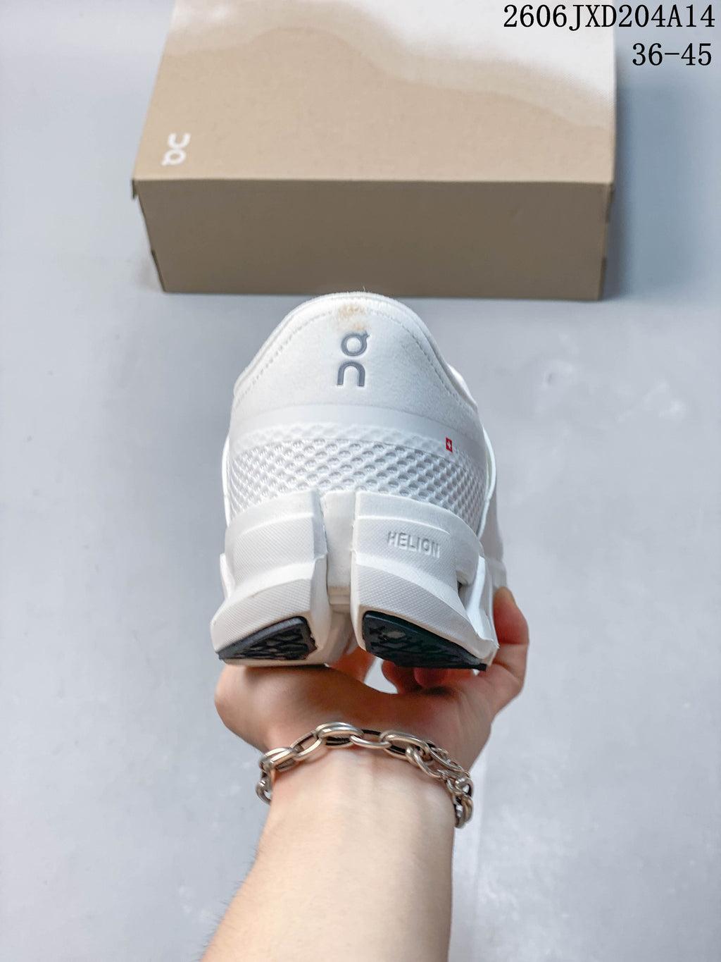 Heel view of a white running shoe with a segmented sole