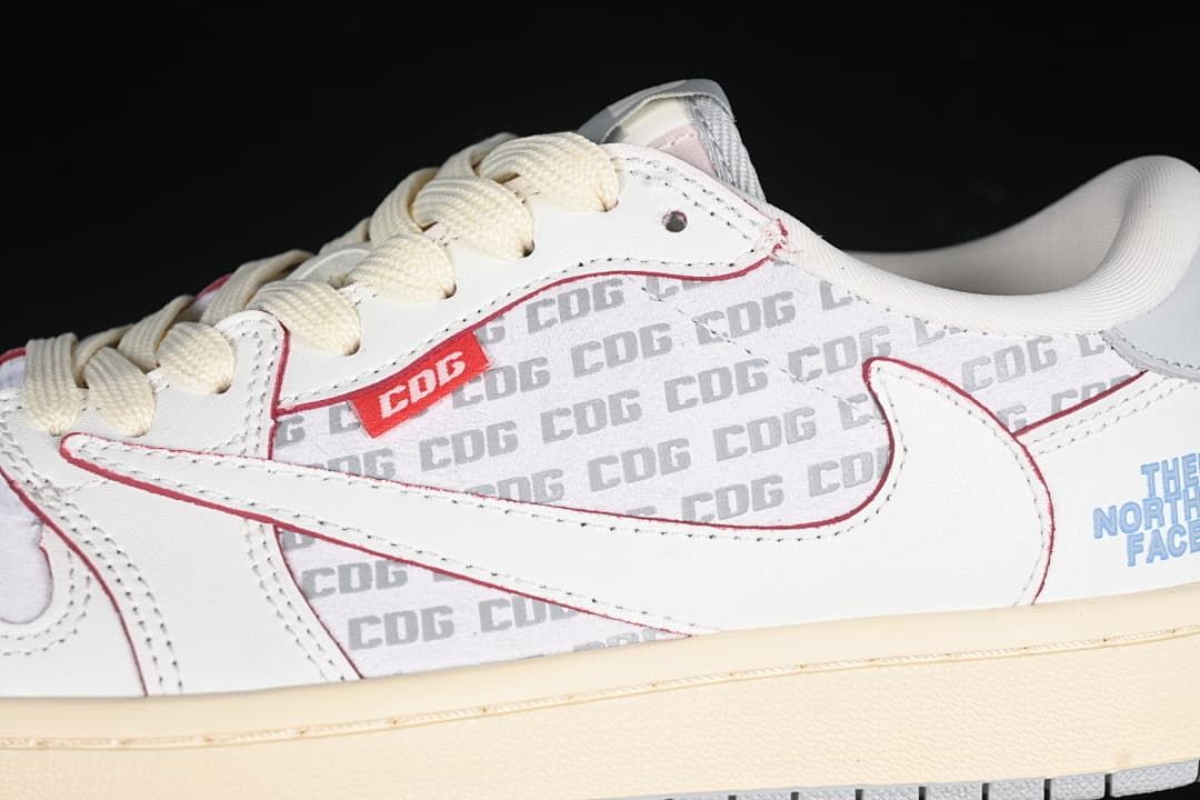 Close-up of patterned side panel, white Swoosh, red trim, and cream laces.