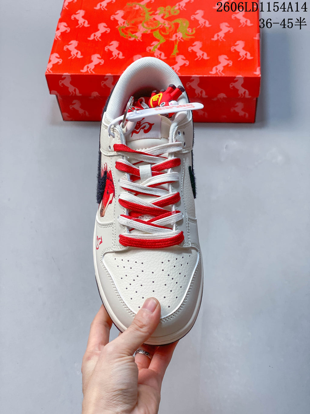 Top view of the sneaker with perforated toe, contrasting laces, and horse graphic