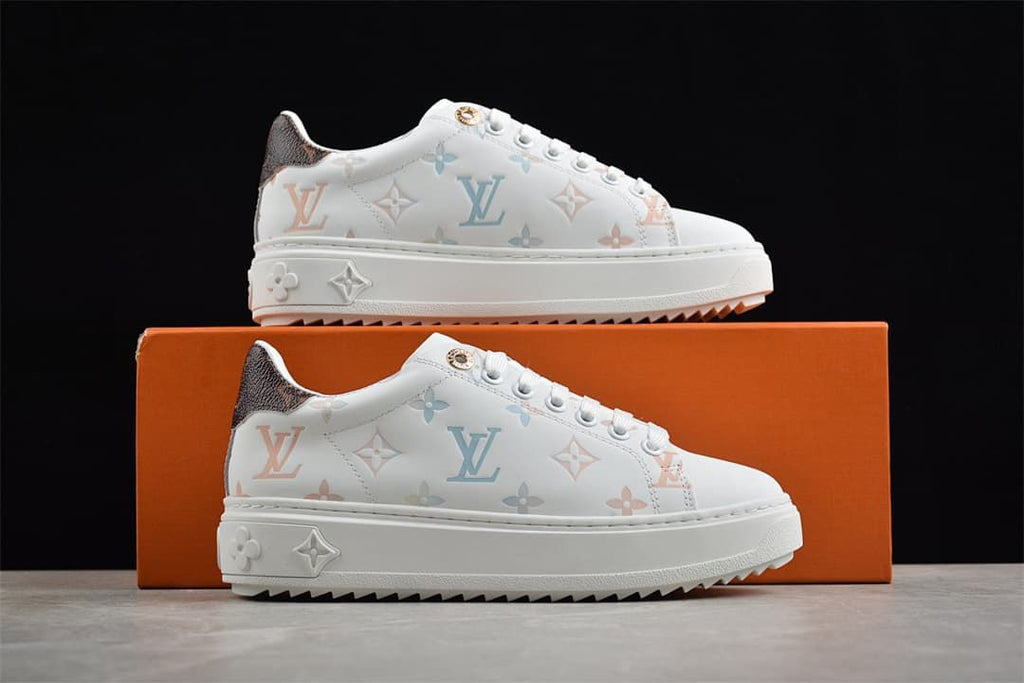 Pair of patterned white platform sneakers displayed with an orange box