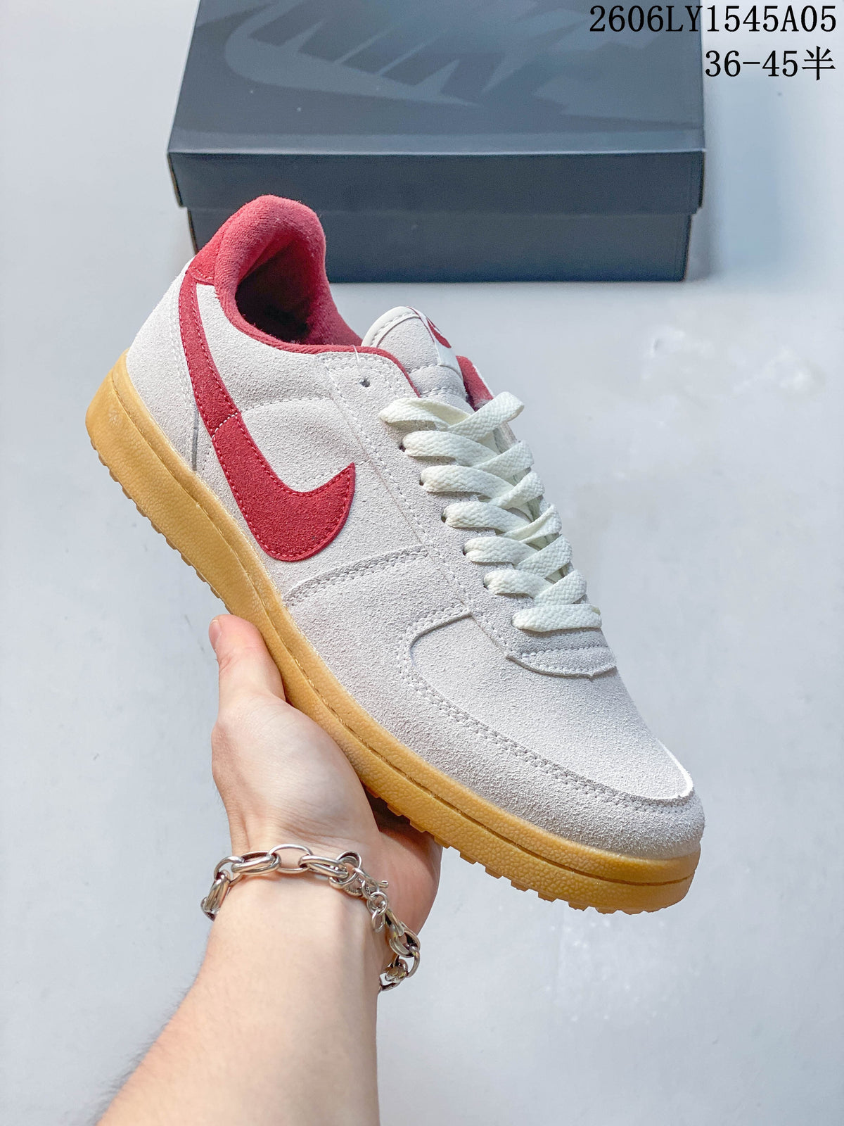 Angled side view of the white and red Nike Field General sneaker