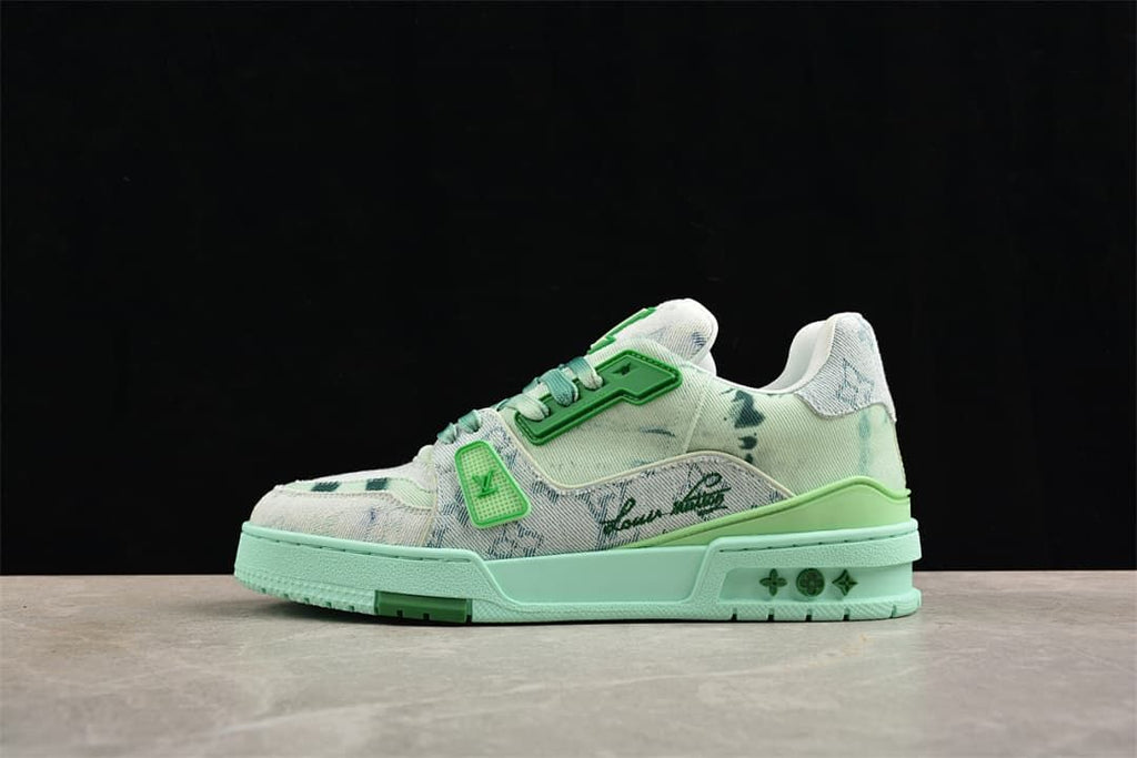 Side view of pale patterned low-top sneakers with green accents and a mint-colored sole.