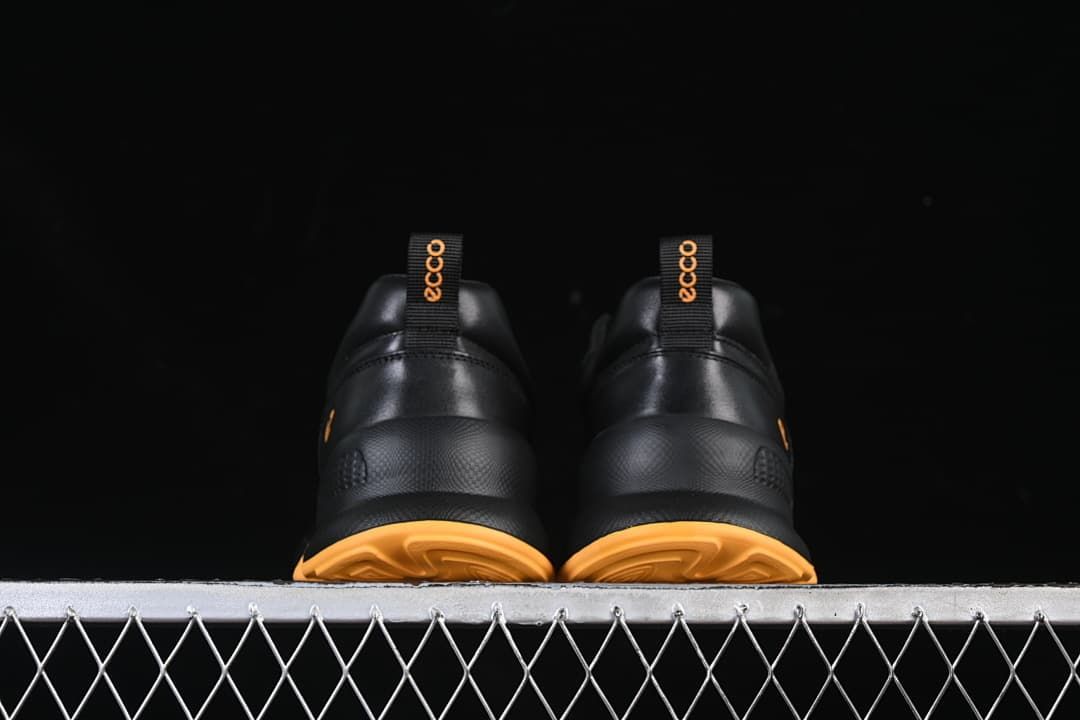 Rear view of the pair showing amber outsoles and heel pull tabs