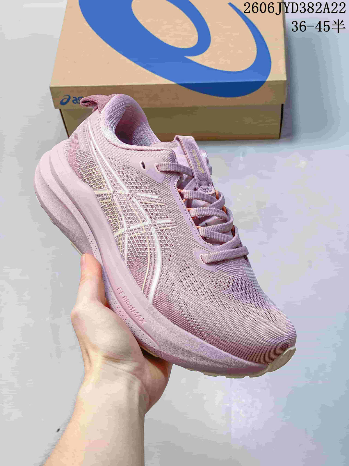 Side view of the pink running shoe with pale detailing