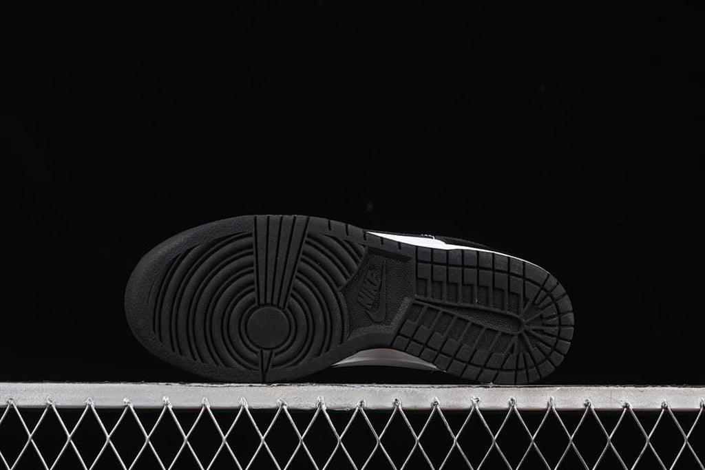 Underside of the sneaker showing a black tread outsole
