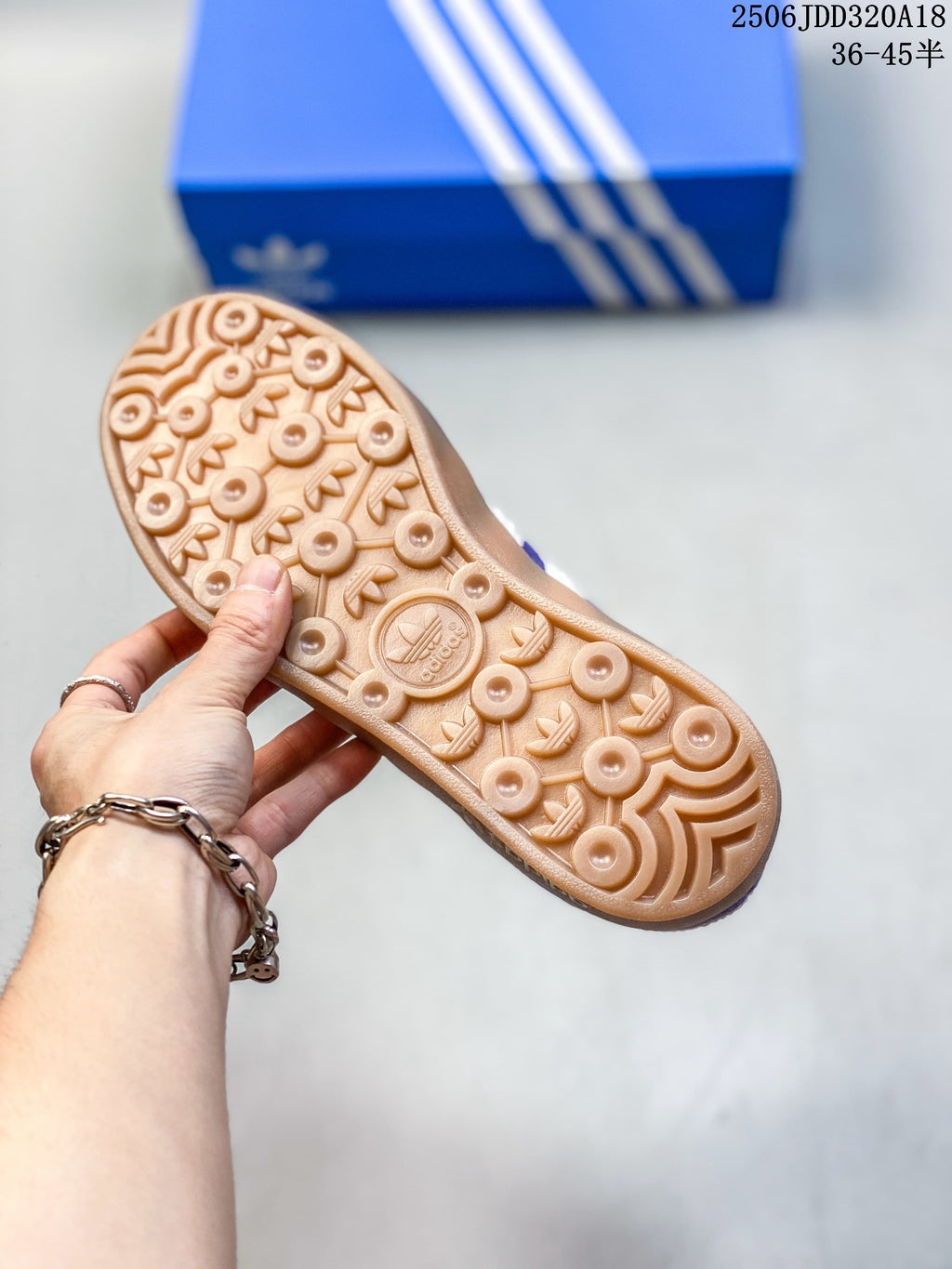 Textured gum-colored outsole of the purple low-top sneaker.