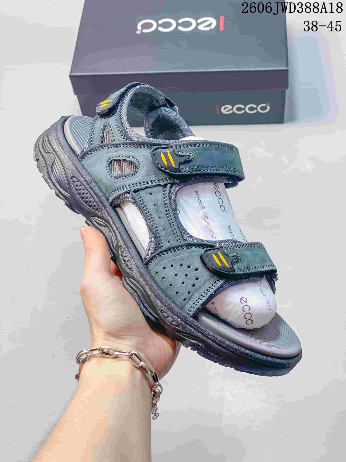 Side view of a gray sandal showing adjustable straps, open toe, and textured outsole.