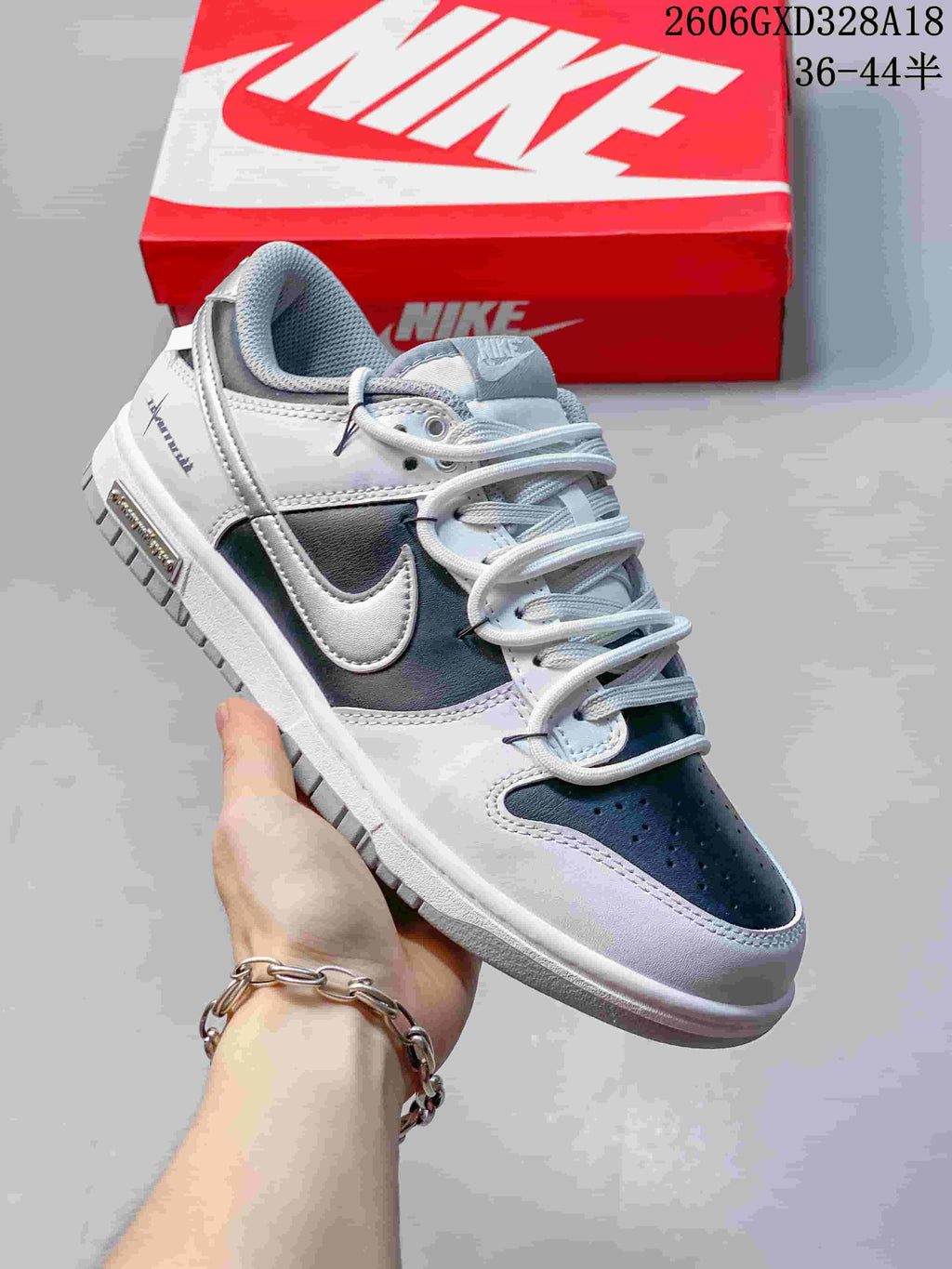 Angled close-up of the white, black, and silver sneaker