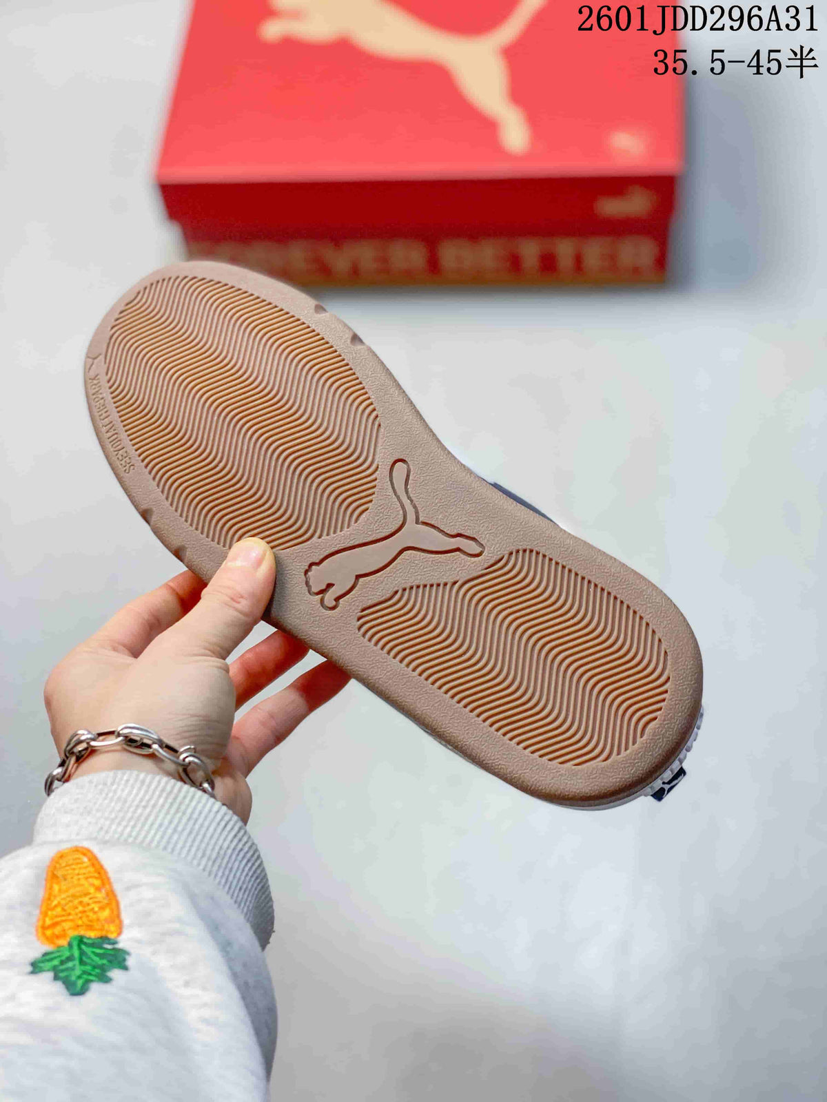 Underside of a PUMA sneaker showing a textured gum-tone outsole