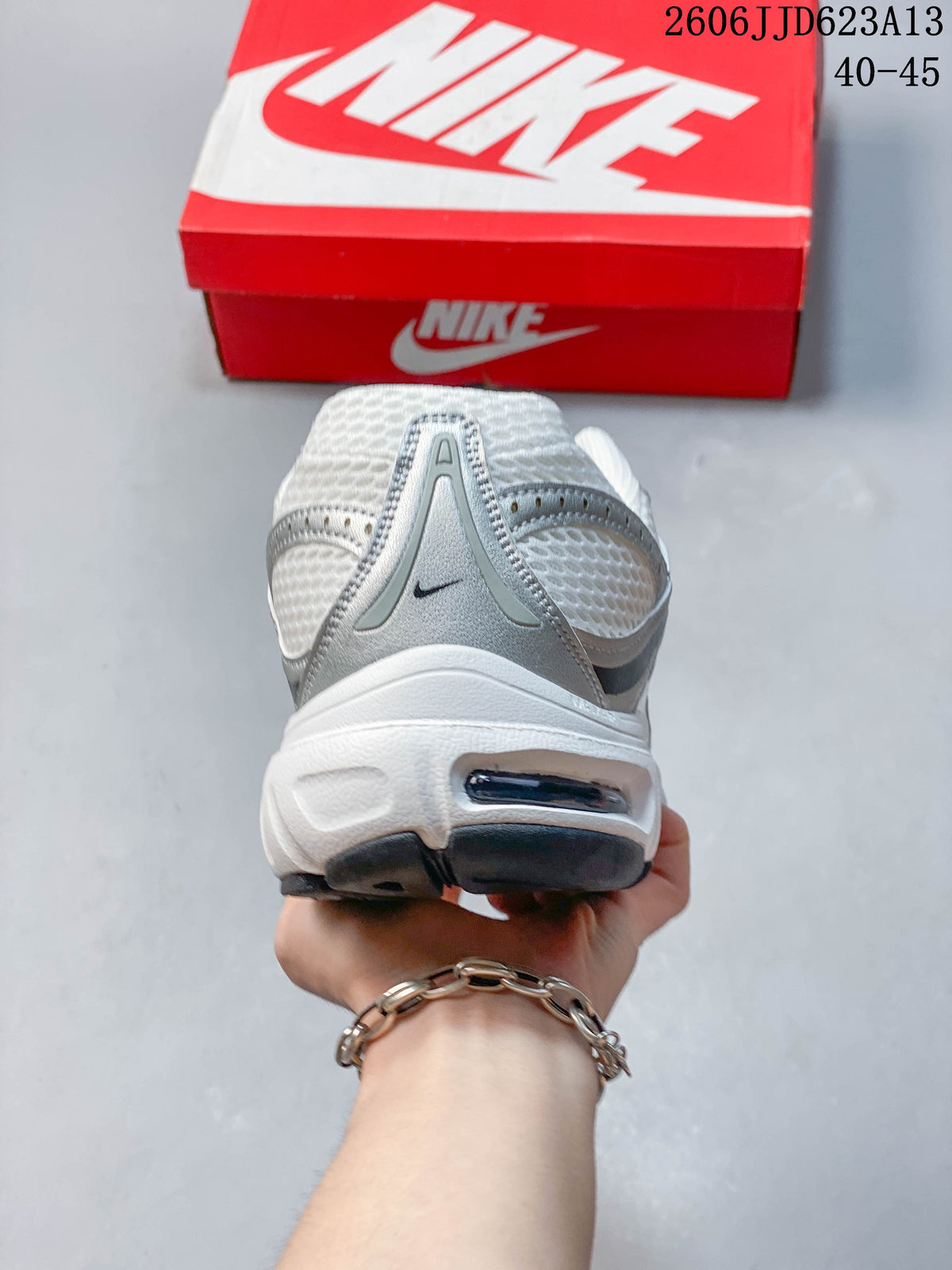 Rear view of the white and silver Nike Air Max Moto 2K sneaker
