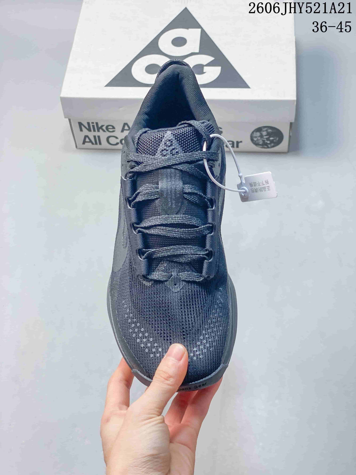 Top view of a dark gray lace-up shoe showing the tongue and perforated toe area.