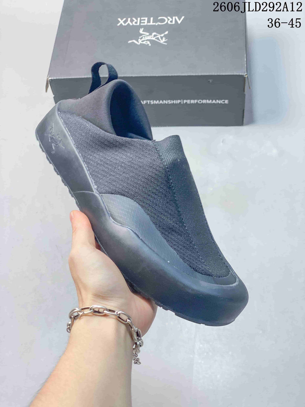 Angled side view of the gray slip-on shoe