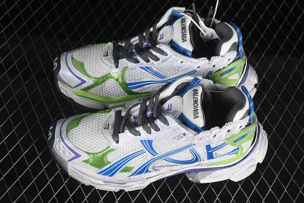 Pair of white Runner-style sneakers with blue, green, and purple accents