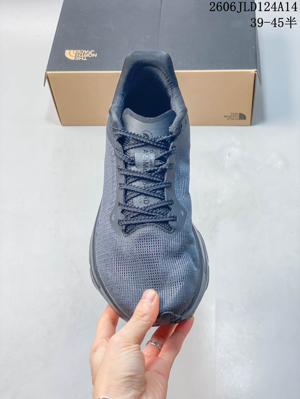 Top view of the gray shoe showing its laces and rounded toe.