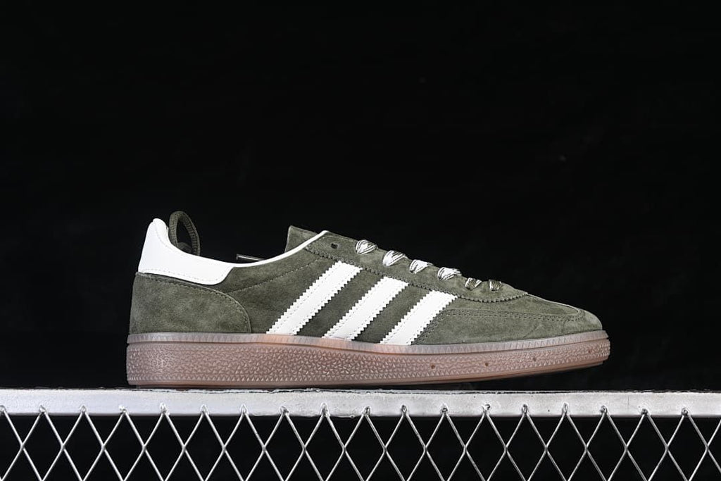 Side profile of a green sneaker with white stripes and gum-colored sole
