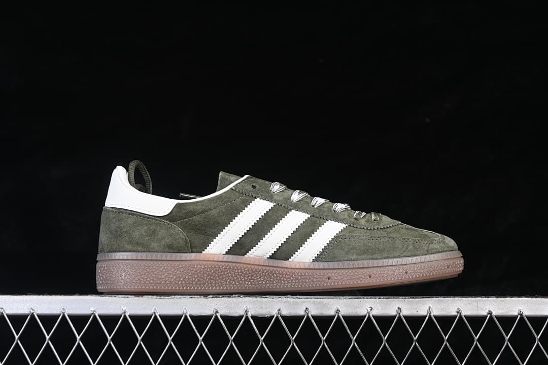 Side profile of a green sneaker with white stripes and gum-colored sole