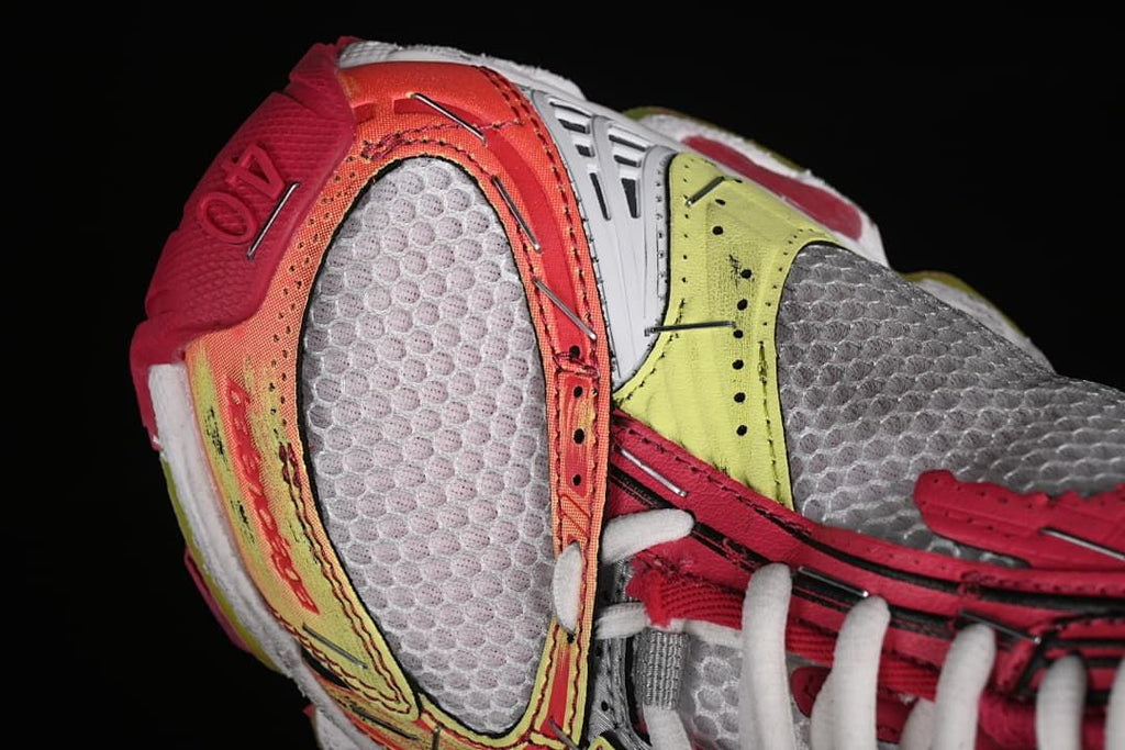 Close-up of the heel area with orange, yellow, and gray panels
